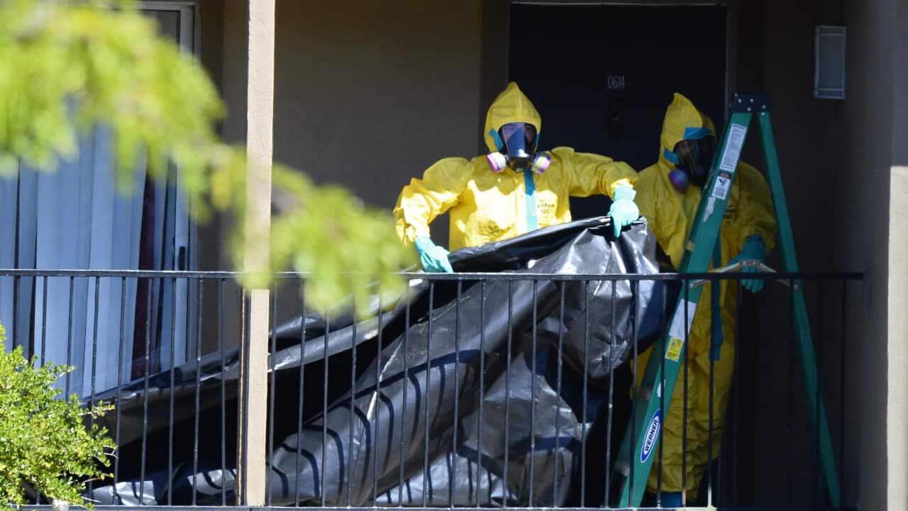Members of the Hazmat crew hang plastic to cover the front door of the apartment where Thomas Eric Duncan the Ebola patient was staying in Dallas (AAP)