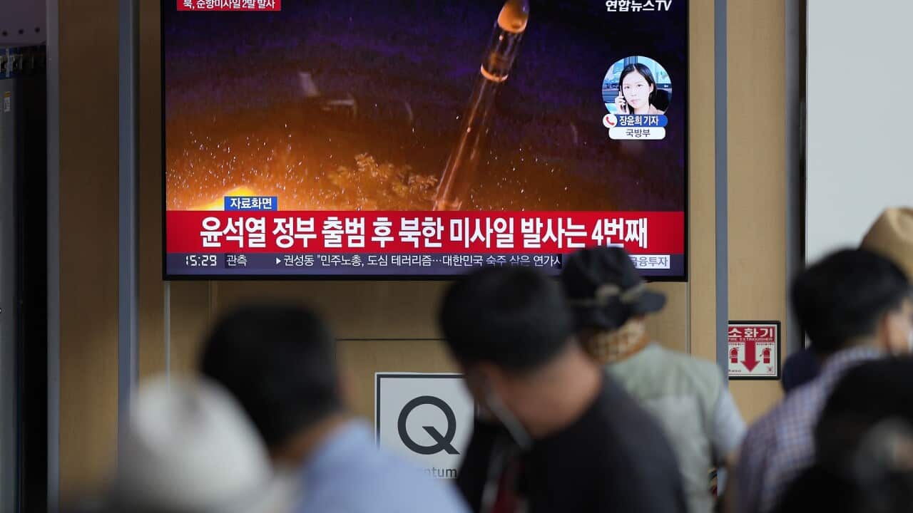 A news program reporting about North Korea's missile launch with file image, is seen at the Seoul Railway Station in Seoul on 17 August 2022.