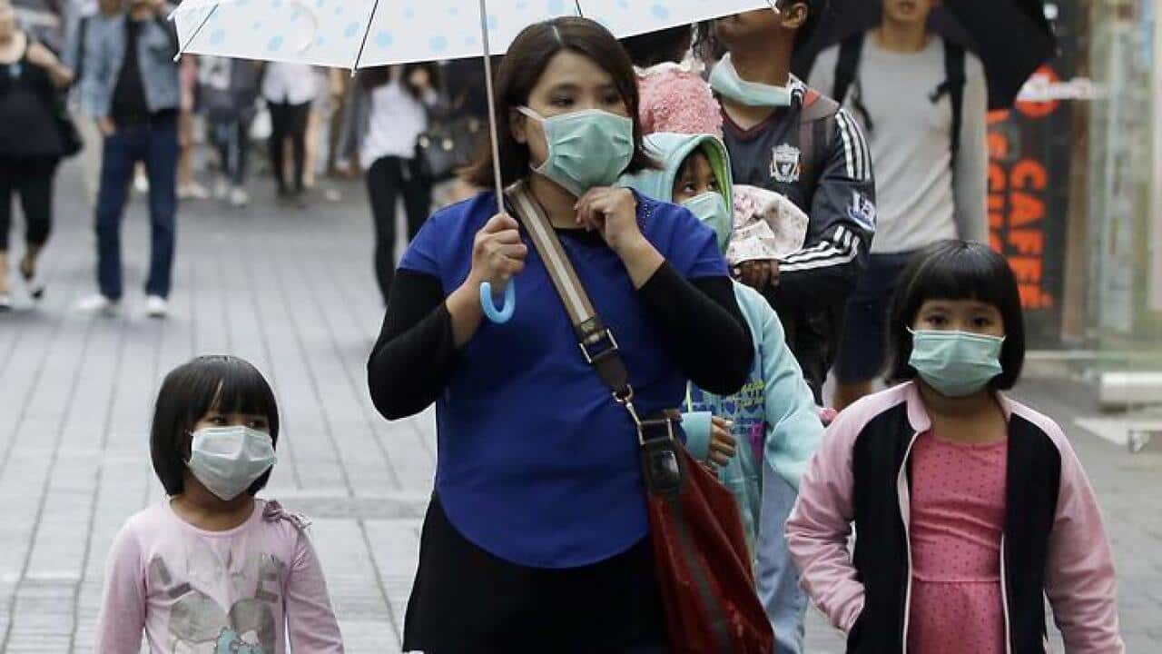 People wear masks as a precaution against MERS virus at a shopping district in Seoul, South Korea