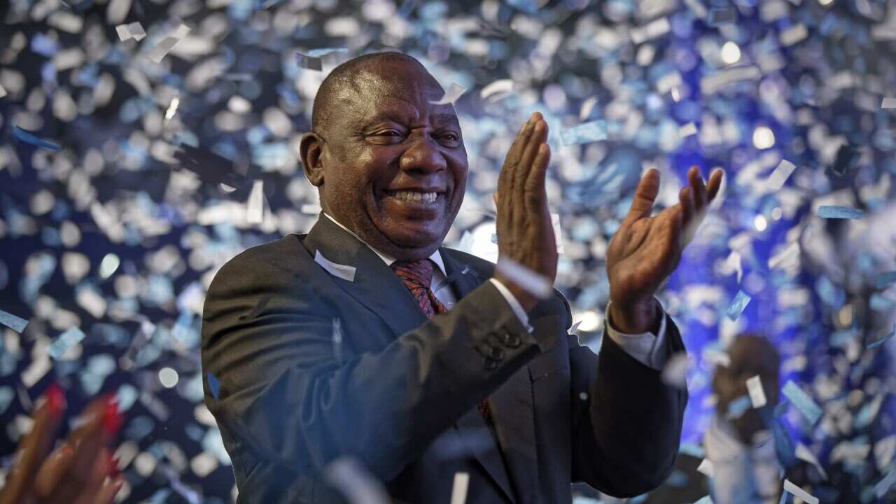 President Cyril Ramaphosa applauds as confetti is launched at the end of the results ceremony at the Independent Electoral Commission Results Center in Pretoria