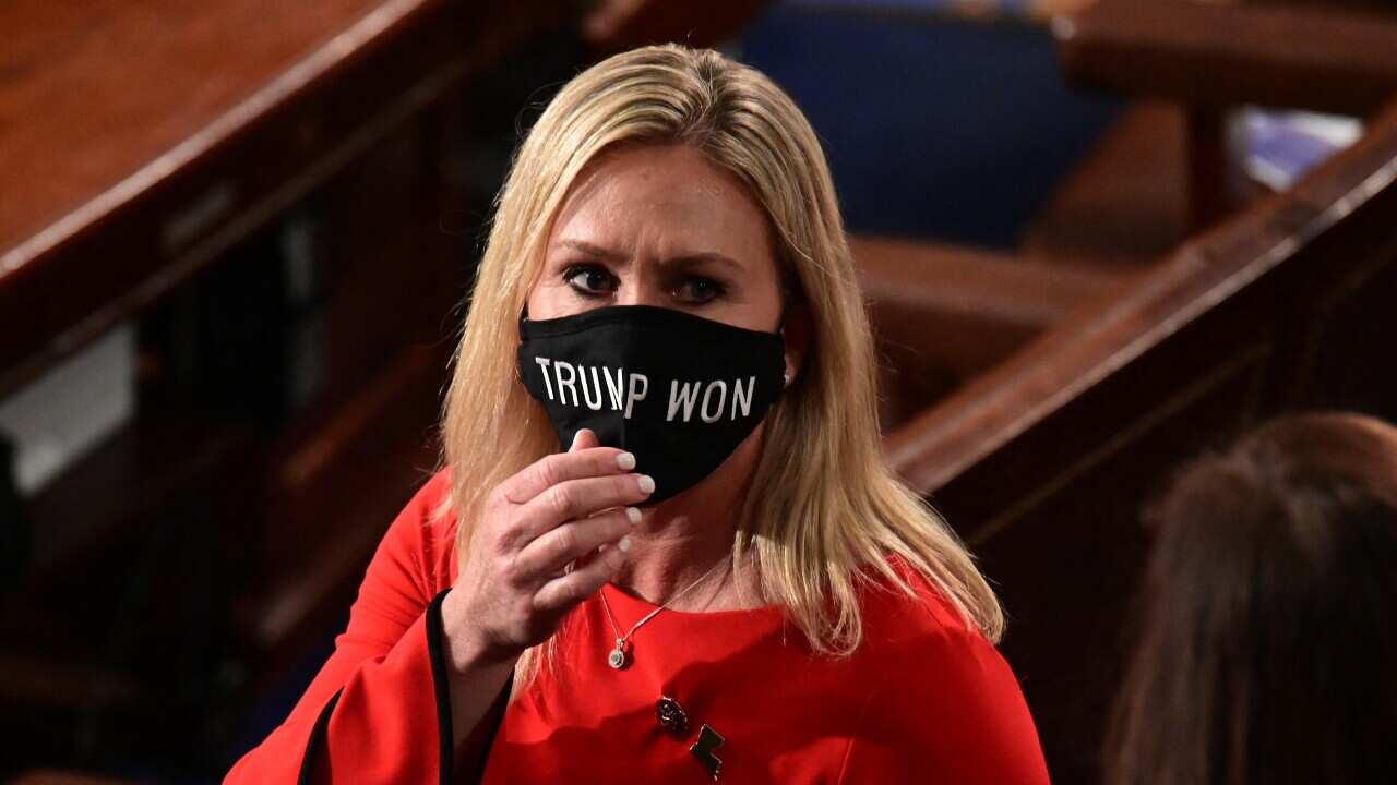 Marjorie Taylor Greene wears a "Trump Won" face mask as she arrives on the floor of the House on 3 January, 2021.