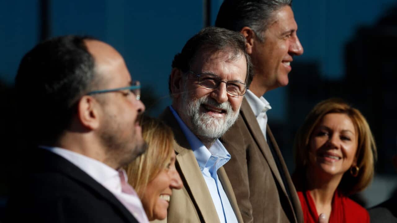 Spain's Prime Minister Mariano Rajoy, center, attends a Catalan regional People's Party meeting in Barcelona, Spain.