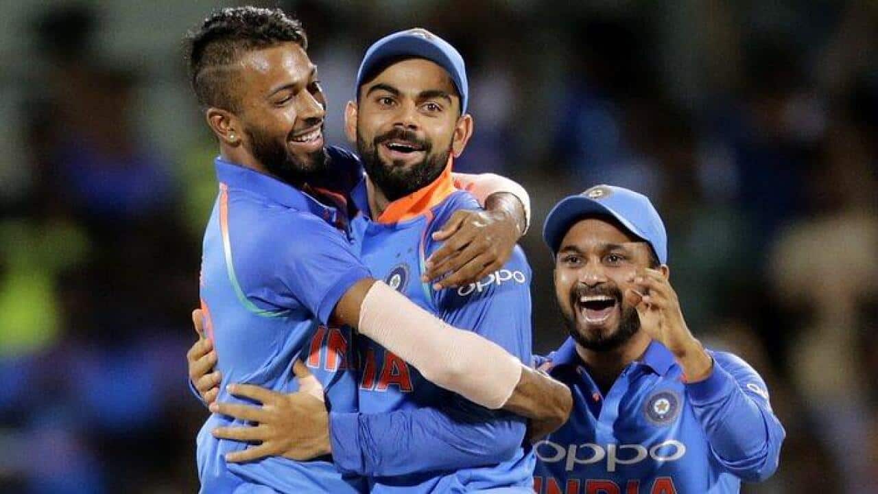 Indian cricket player Hardik Pandya, left celebrates with captain Virat Kohli, center and Kedar Jadhav after taking Steven Smith's wicket. (AAP Image/AP Photo/Rajanish Kakade)