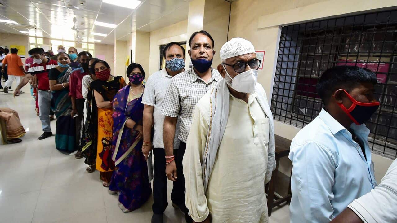 People stand in a queue to get inoculated with the Covid-19 coronavirus vaccine at Moti Lal Nehru Medical College in Allahabad on April 6, 2021. (Photo by SANJAY KANOJIA / AFP) (Photo by SANJAY KANOJIA/AFP via Getty Images)