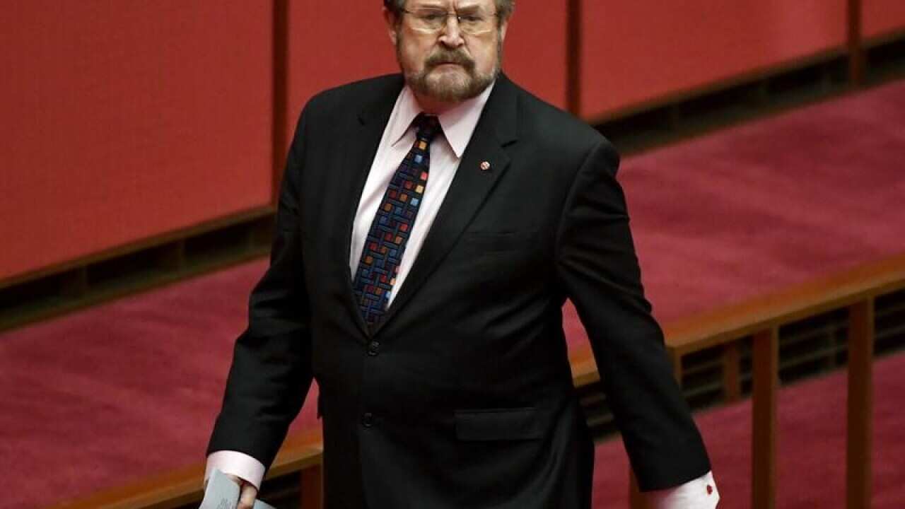 Justice Party Senator Derryn Hinch arrives for Question Time.