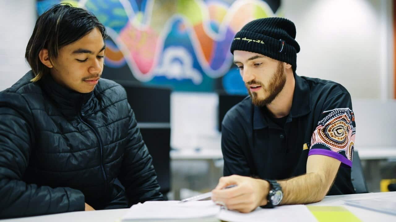Daniel Curran tutoring a student in the Indigenous Tutorial Assistance Scheme at Curtin’s Centre for Aboriginal Studies.