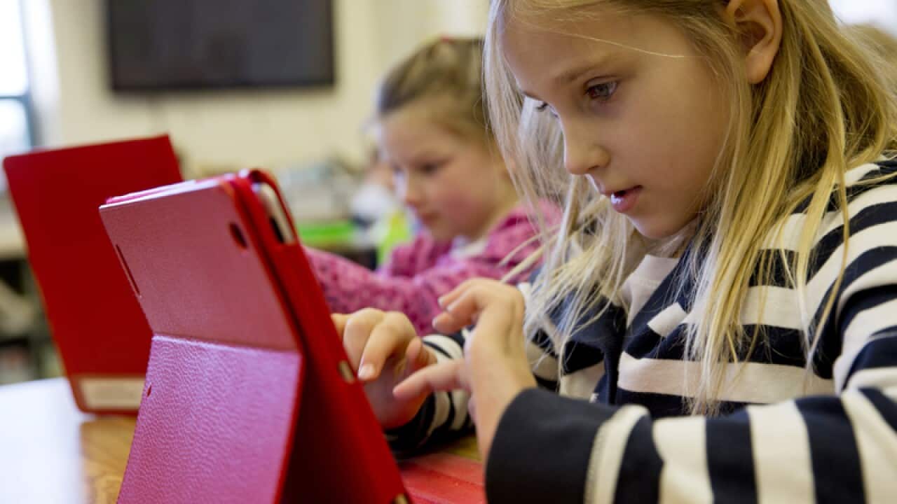 A girl works on an iPad