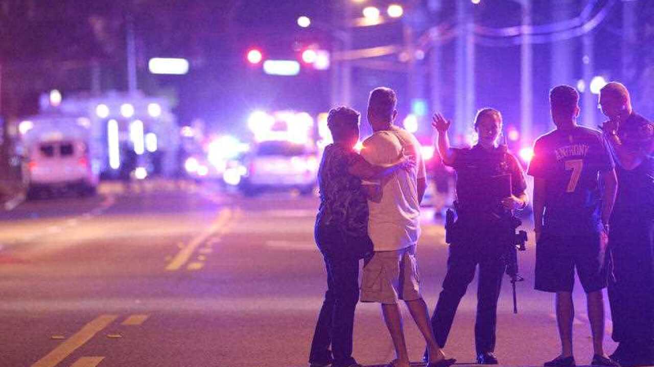 Orlando Police officers direct family members away from a fatal shooting at Pulse Orlando nightclub in Orlando, Fla., Sunday, June 12, 2016.