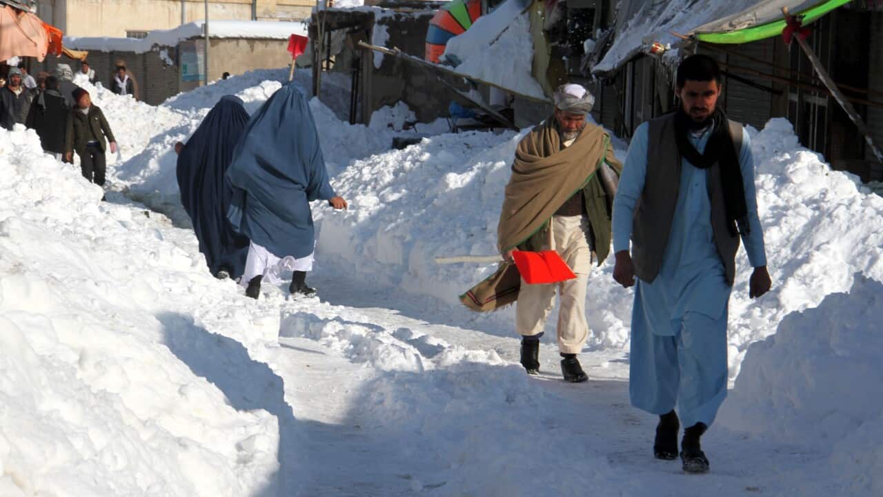 People make their way through a snowy road in Ghazni, Afghanistan, 05 February 2017.