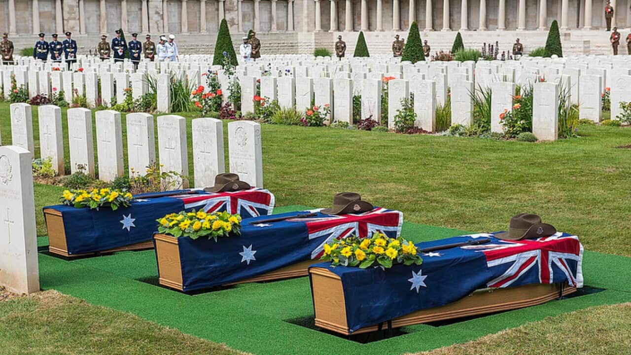 Coffins containing the remains of an unknown WWI digger are seen at a military funeral at the local war cemetery, Pozieres in northern France