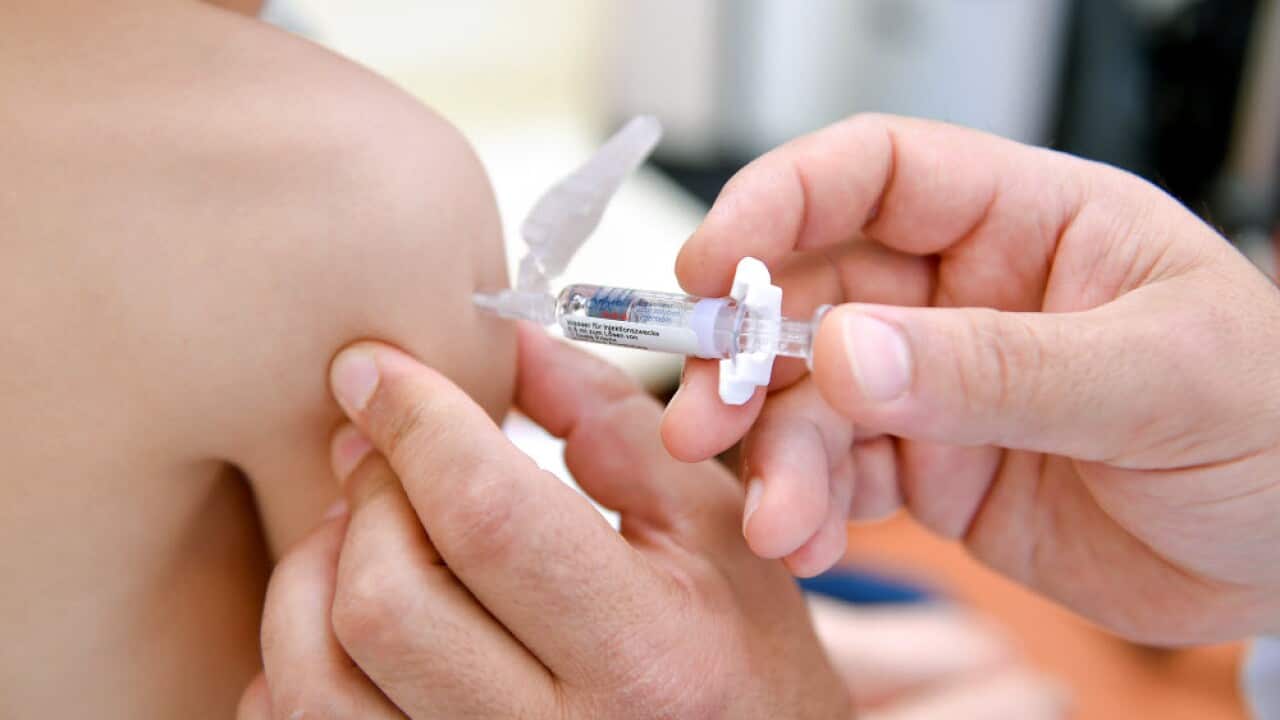 A pediatrician shows a measles vaccine