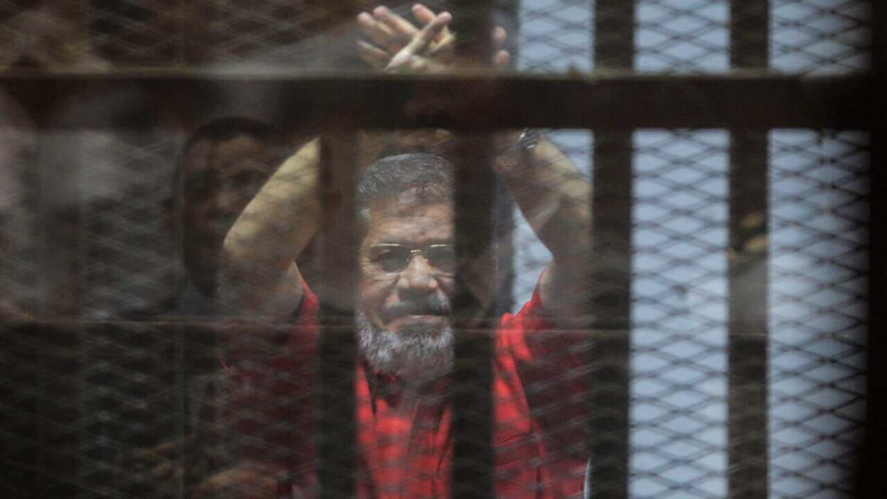 Ousted Egyptian President Mohamed Morsi looks on during a trial on charges of espionage in Cairo.