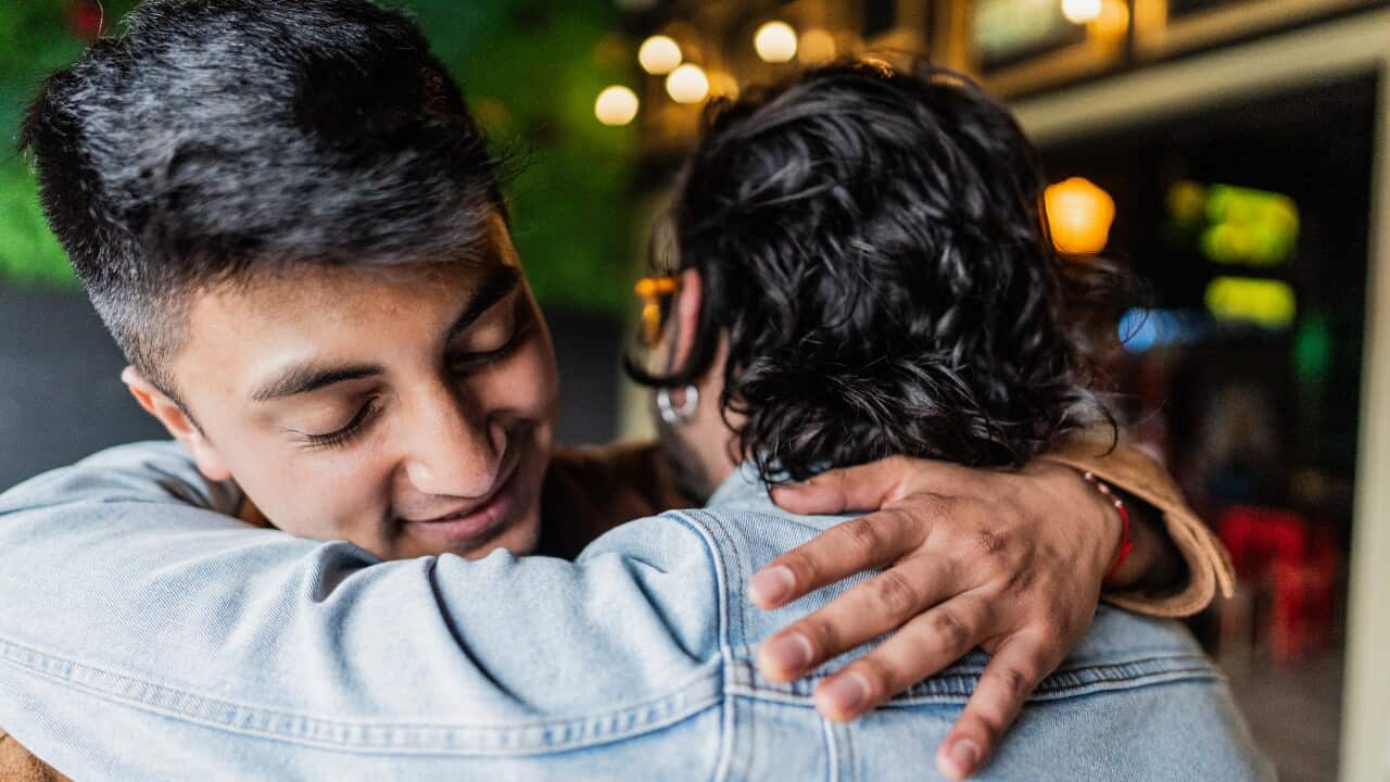 Friends embracing at the restaurant