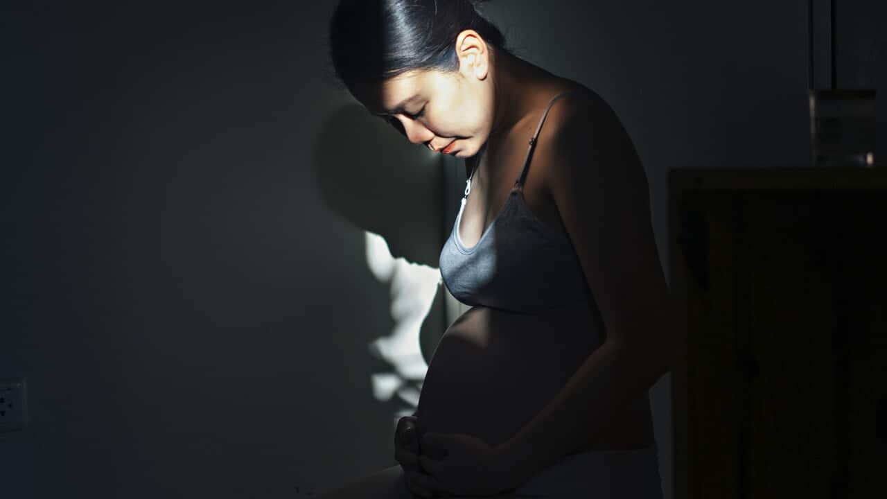 asian female young adult pregnant wearing maternity wear feel enjoyment and relaxation with strong and contrast light