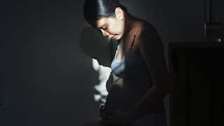 asian female young adult pregnant wearing maternity wear feel enjoyment and relaxation with strong and contrast light