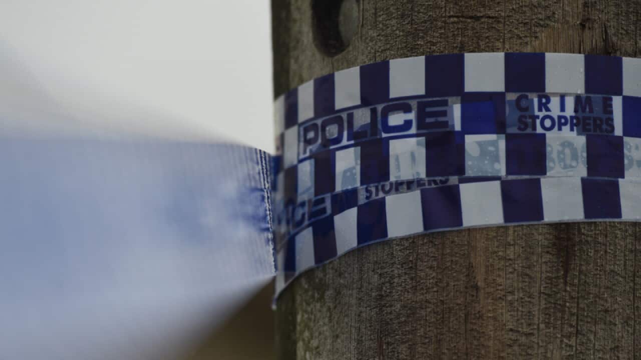 Police tape is seen at a home