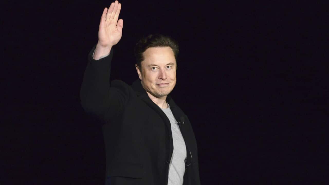 Elon Musk waving.