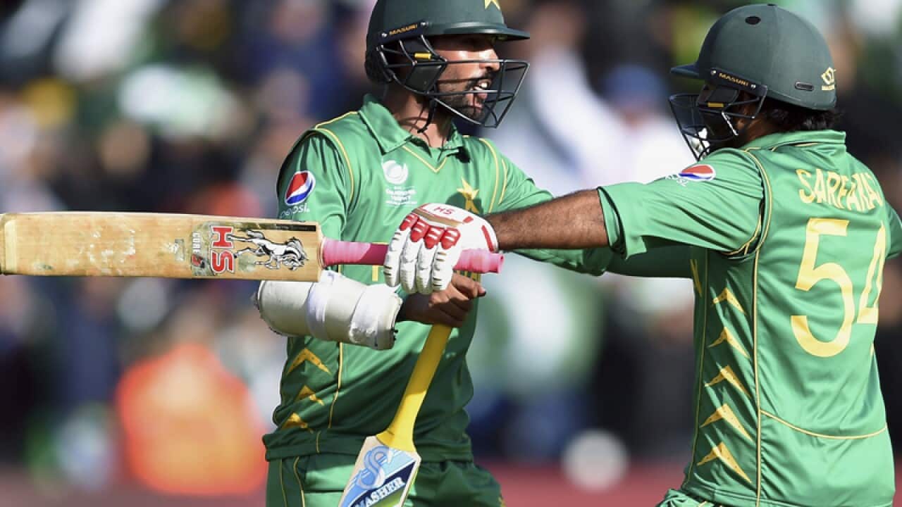 Pakistan's Sarfraz Ahmed (R) and Mohammad Amir