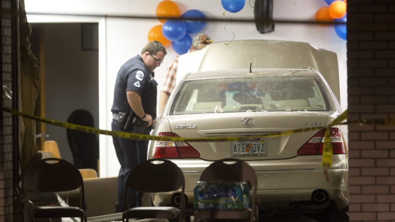 A police officer investigates the scene of a vehicle accident