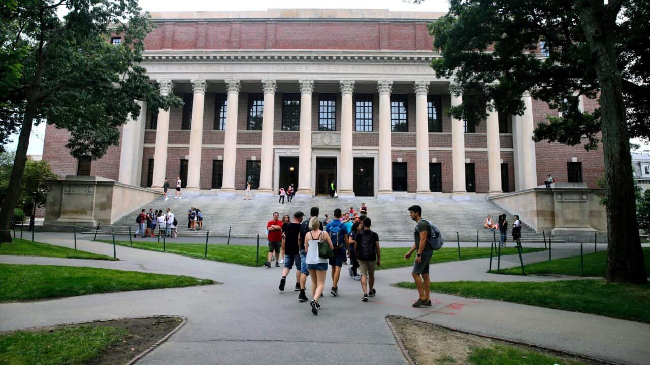 In this Aug. 13, 2019 file photo, students walk near the Widener Library in Harvard Yard at Harvard University