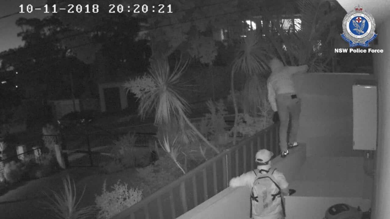CCTV footage shows two members breaking and entering a property in Sydney. (NSW Police)
