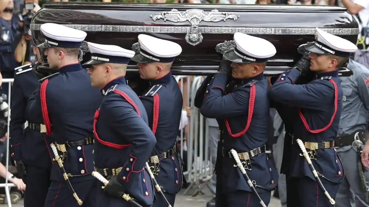 The coffin of soccer legend Pele arrives at a Santos cemetery .jpg