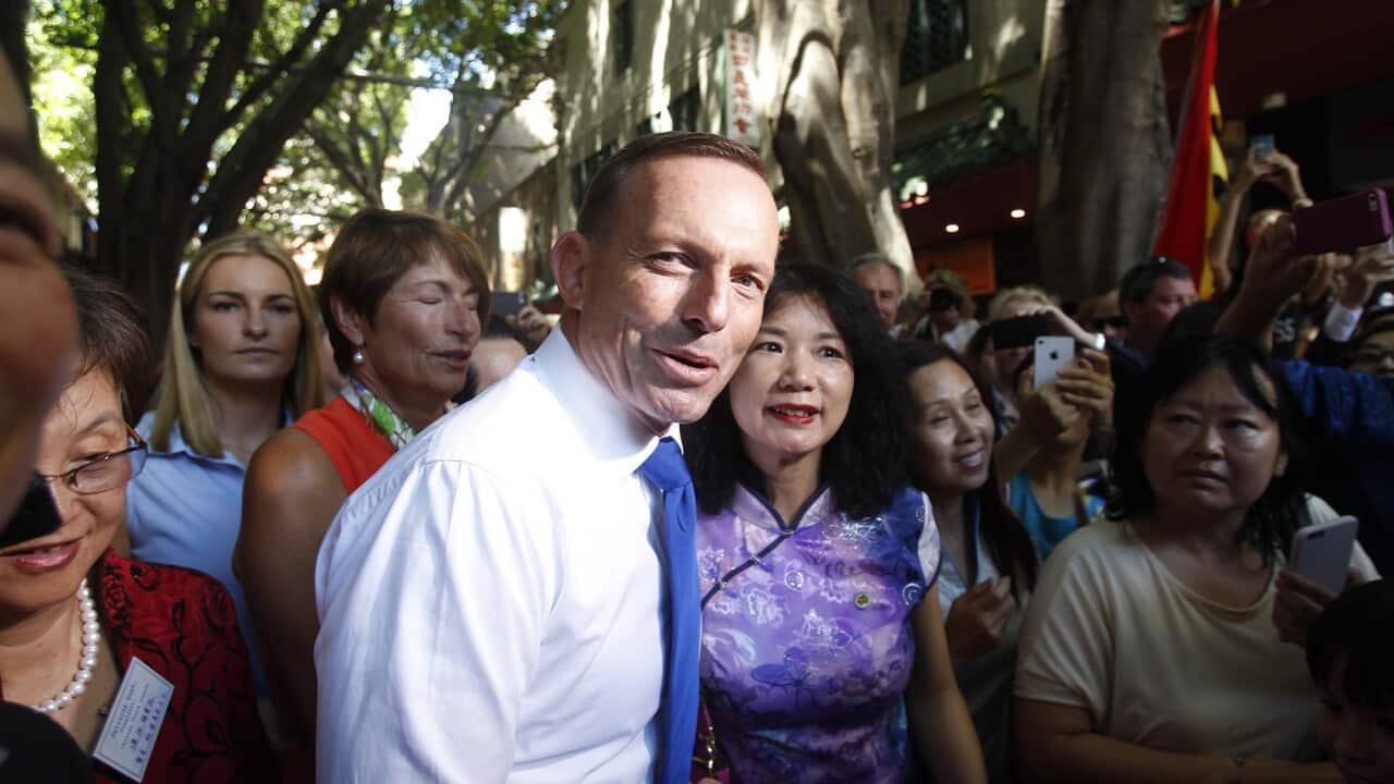 Australian Prime Minister Tony Abbott during a visit to Chinatown in Sydney with his wife Margie and daughter Bridget, Sun, Feb 8. 2015. (AAP Image/Quentin Jones) NO ARCHIVING.