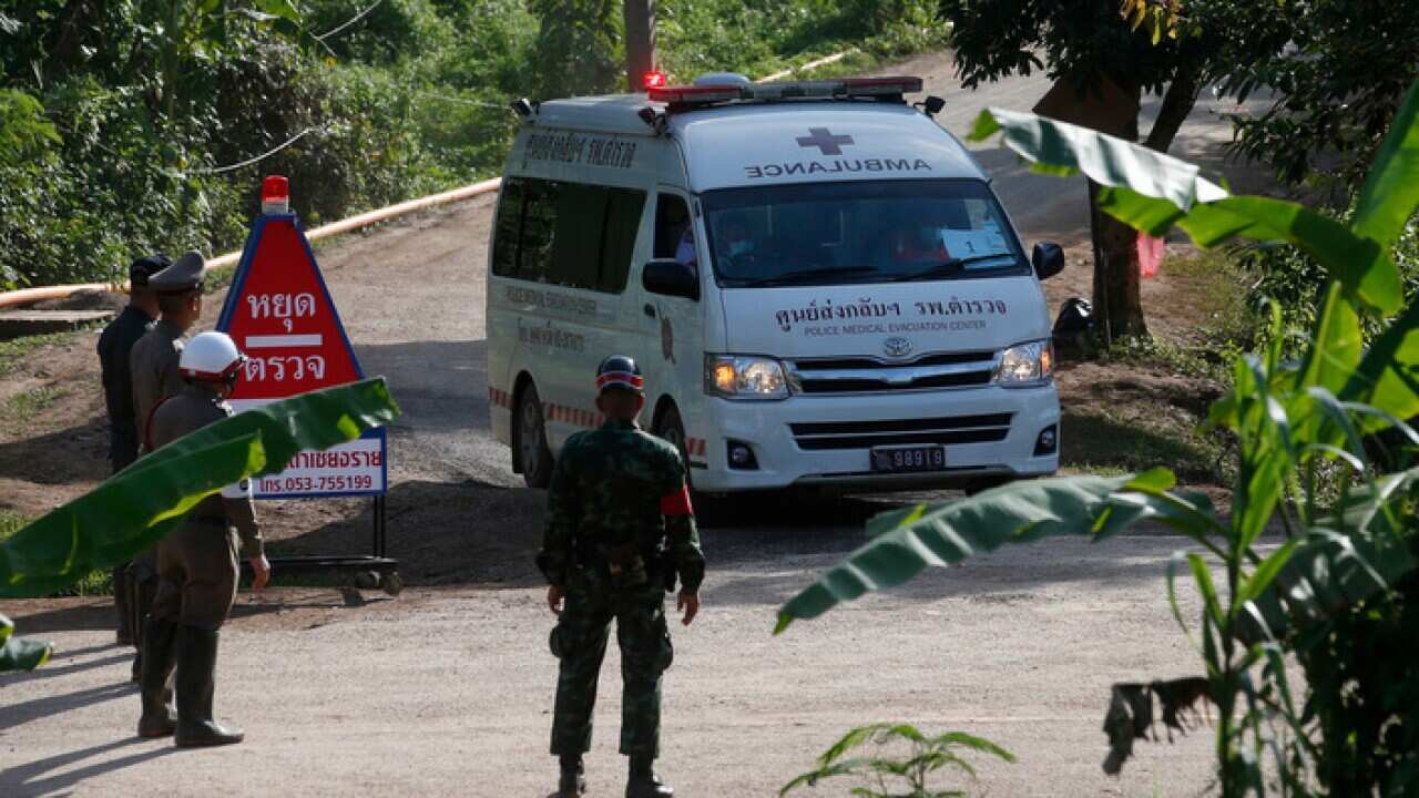 An ambulance with flashing lights leaves the cave rescue area in Mae Sai, Chiang Rai province, northern Thailand.