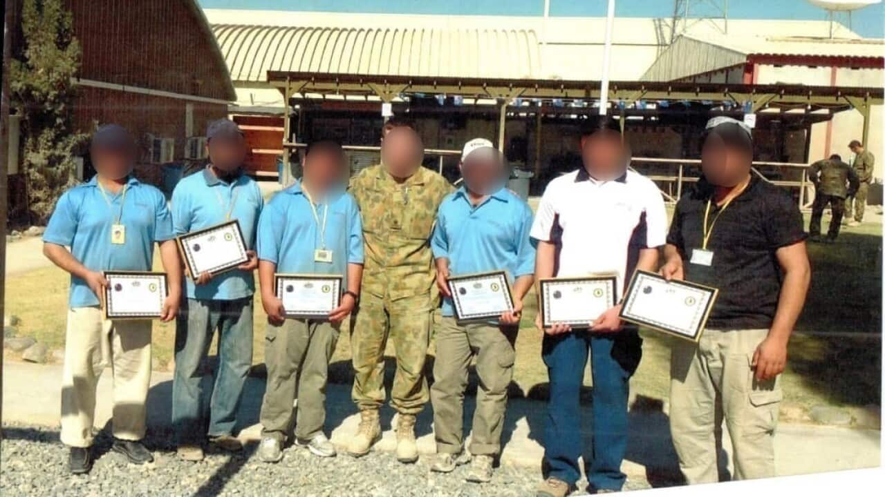 Wali* (second from right) worked as a cleaner at the Kandahar Air Field alongside Australian forces.