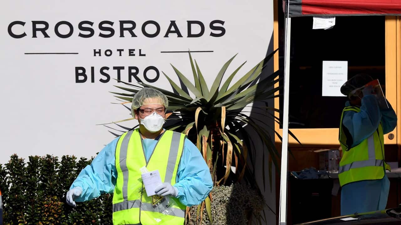 Health workers outside the Crossroads Hotel in Sydney