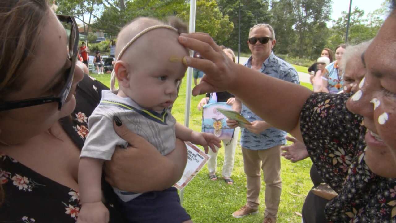 A mother and child from the Waijungbah Jarjums program get painted by elders on the Gold Coast for the first Welcome Baby to Country Smoking Ceremony.