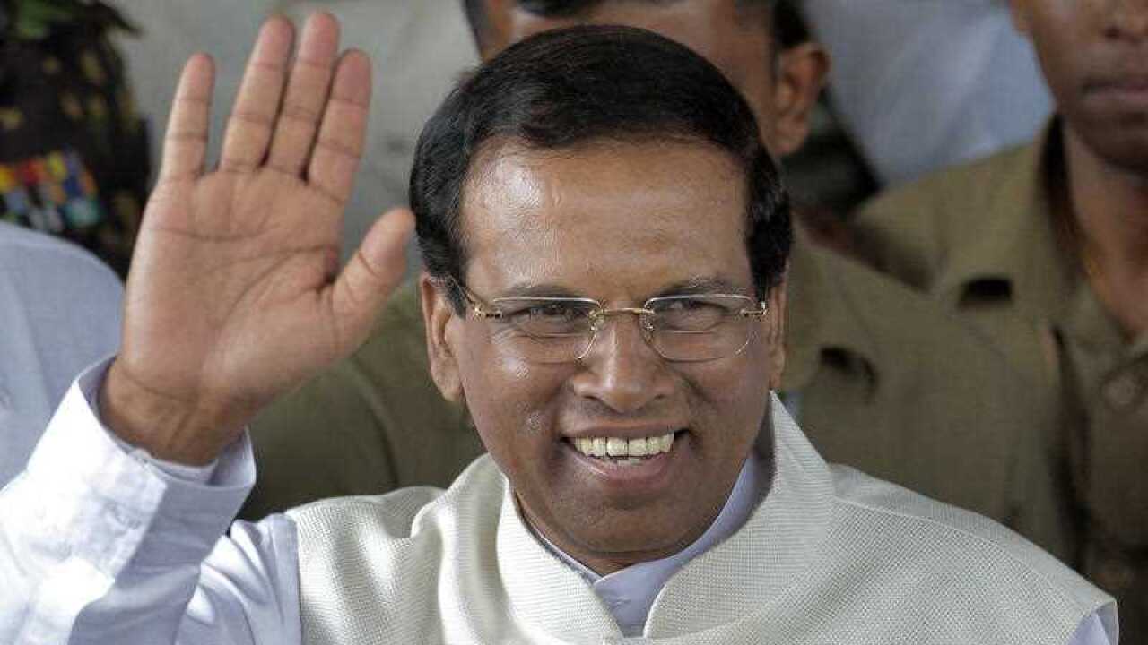 Sri Lanka incoming President Maithripala Sirisena waves to supporters as he leaves the election secretariat in Colombo, Sri Lanka, Friday, January 9, 2015.