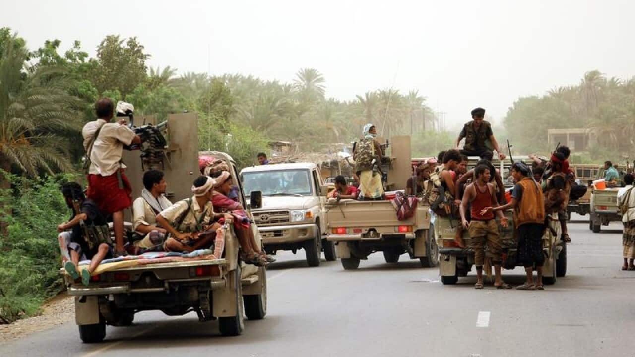 Yemeni government forces and vehicles.