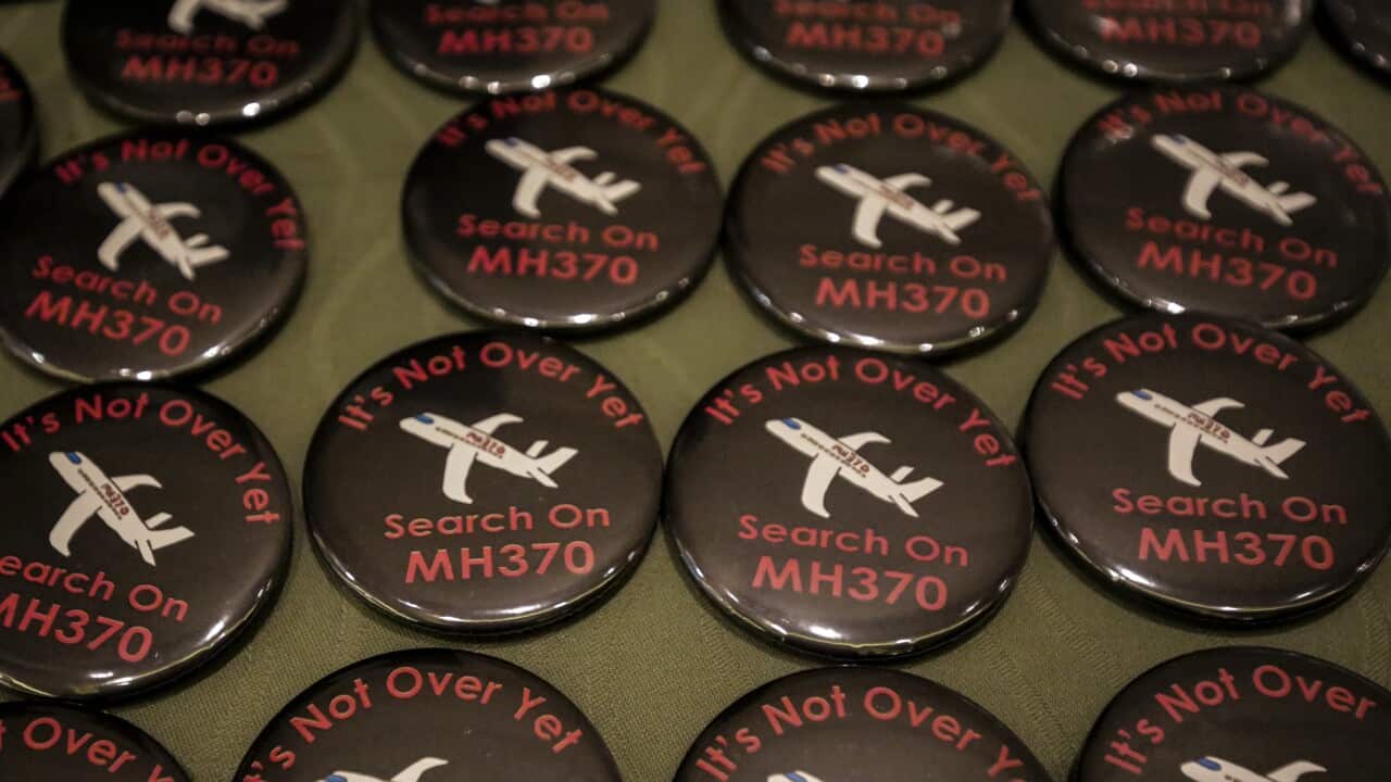 Buttons with the slogan 'The search on MH370 its not over yet' are on display during the remembrance ceremony to mark the sixth anniversary.