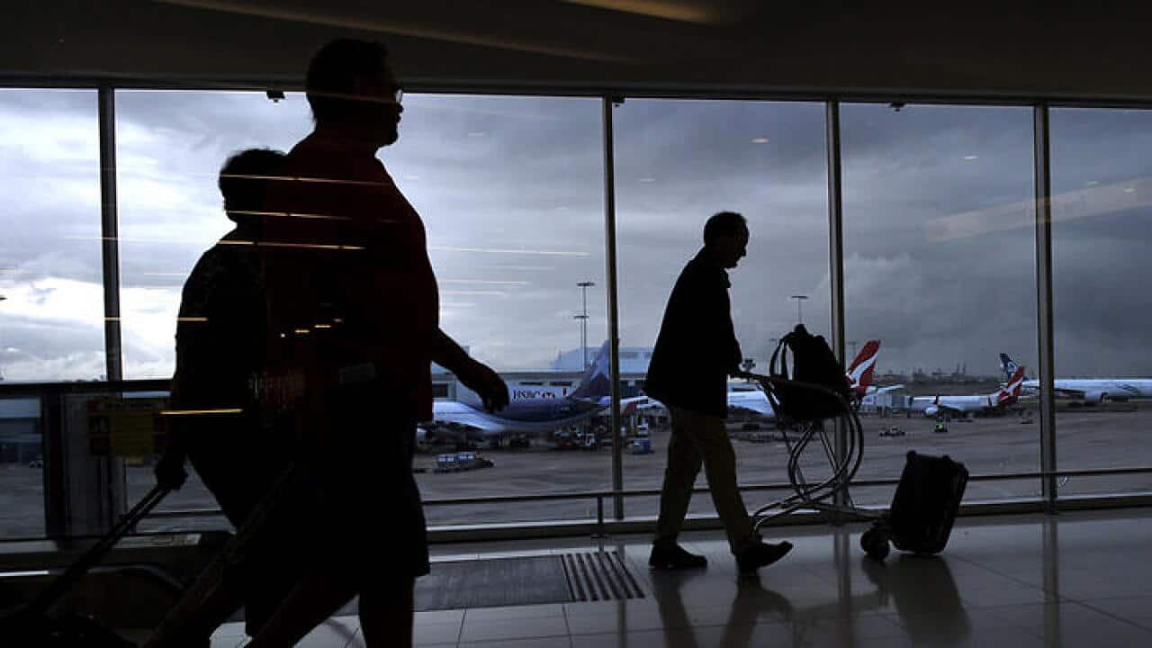 Tourists at the international airport in Sydney, Monday, April 1, 2013. (AAP Image/Paul Miller) NO ARCHIVING, EDITORIAL USE ONLY