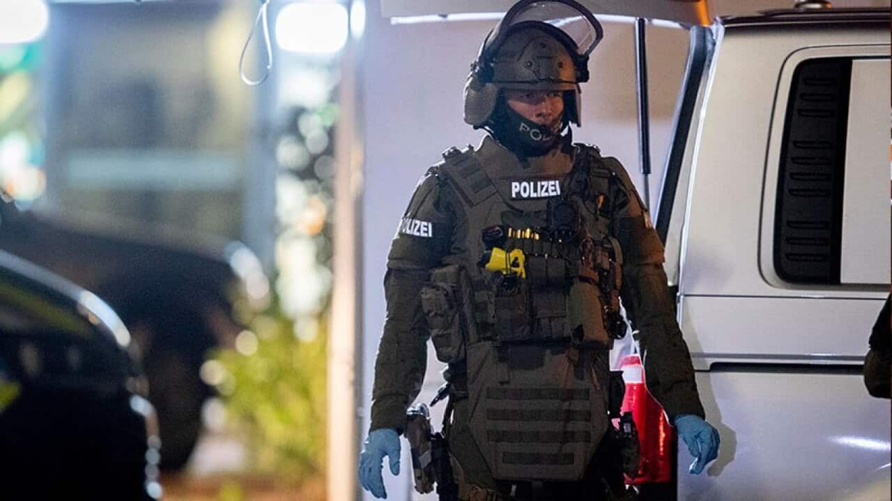 Police and paramedics work at a crime scene after two shootings in Hanau, near Frankfurt, Germany,