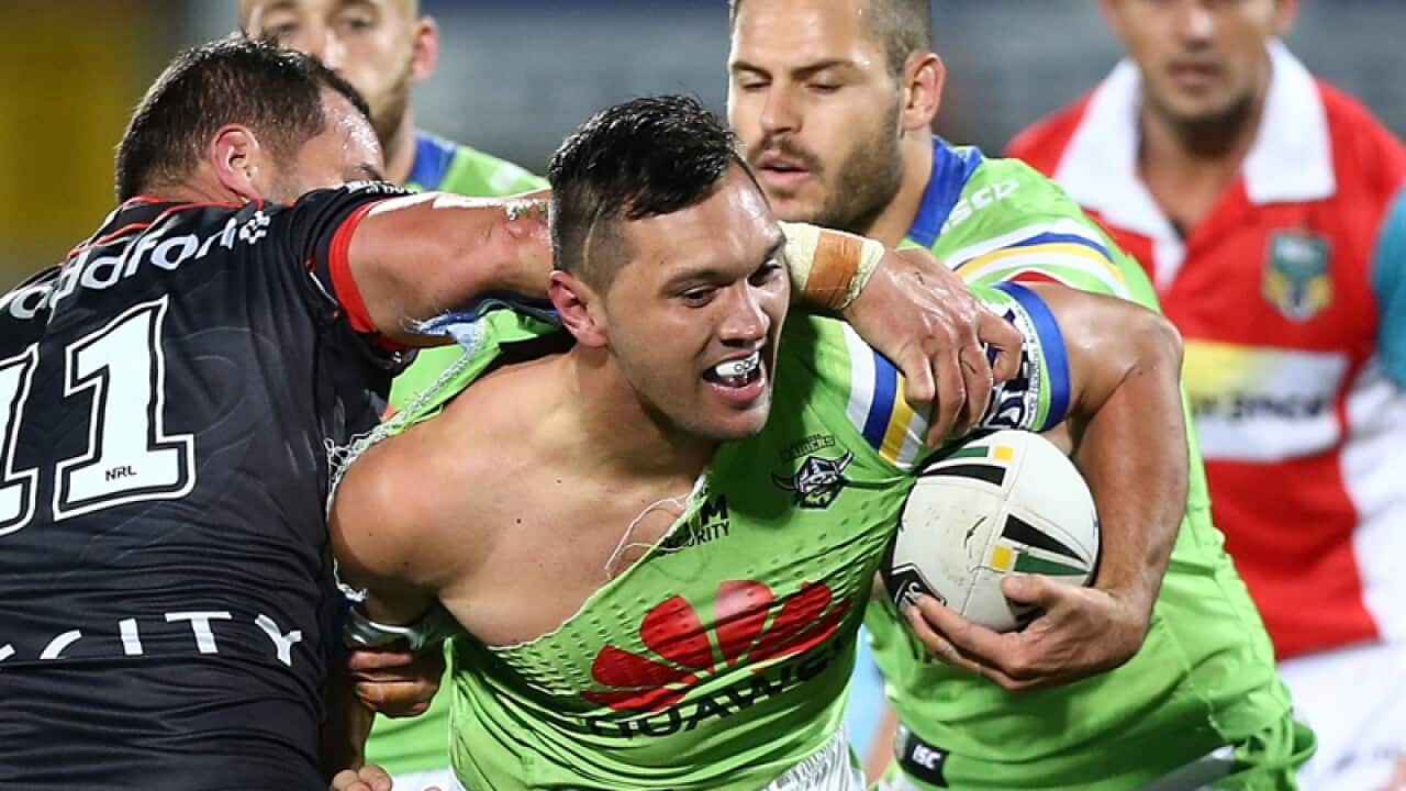 Jordan Rapana of the Raiders is tackled by Bodene Thompson