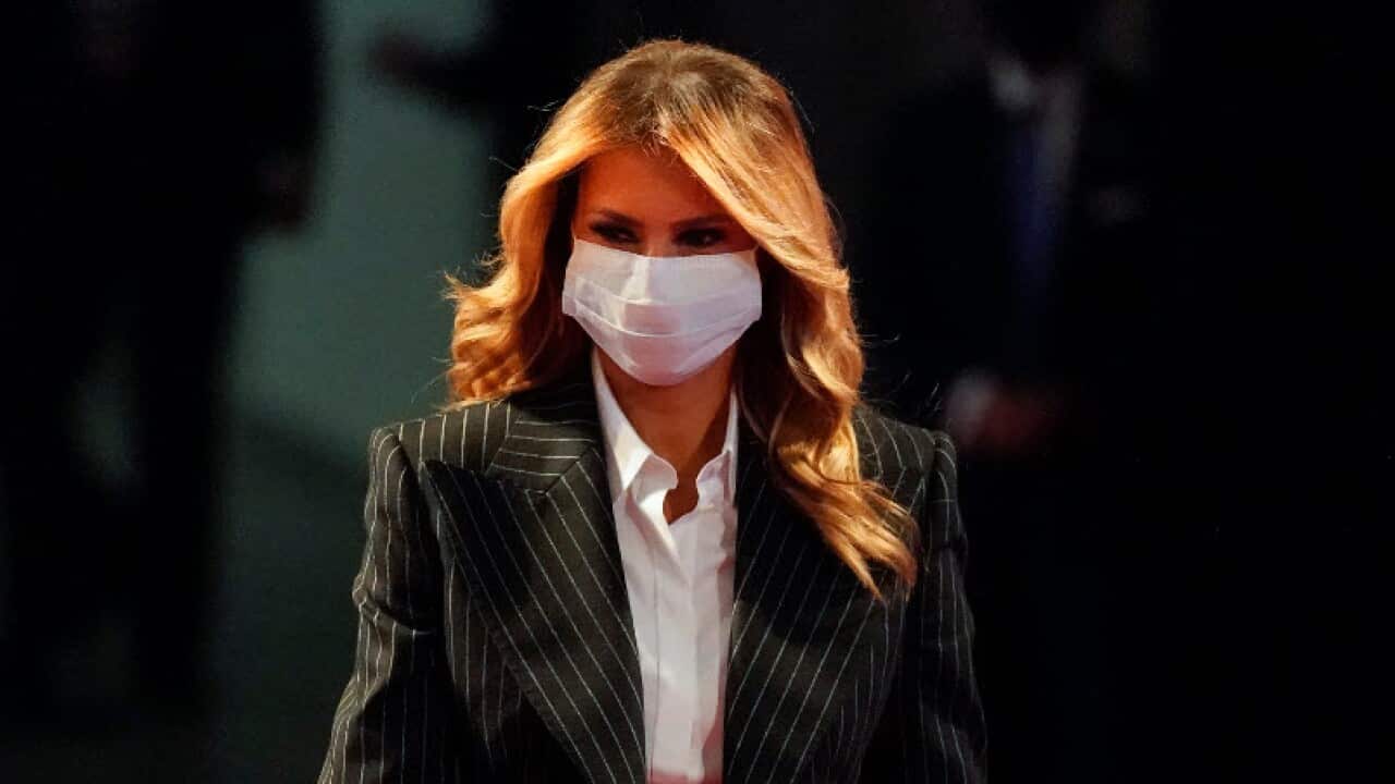 First lady Melania Trump, wearing a facemask, walks towards her seat before the first presidential debate.