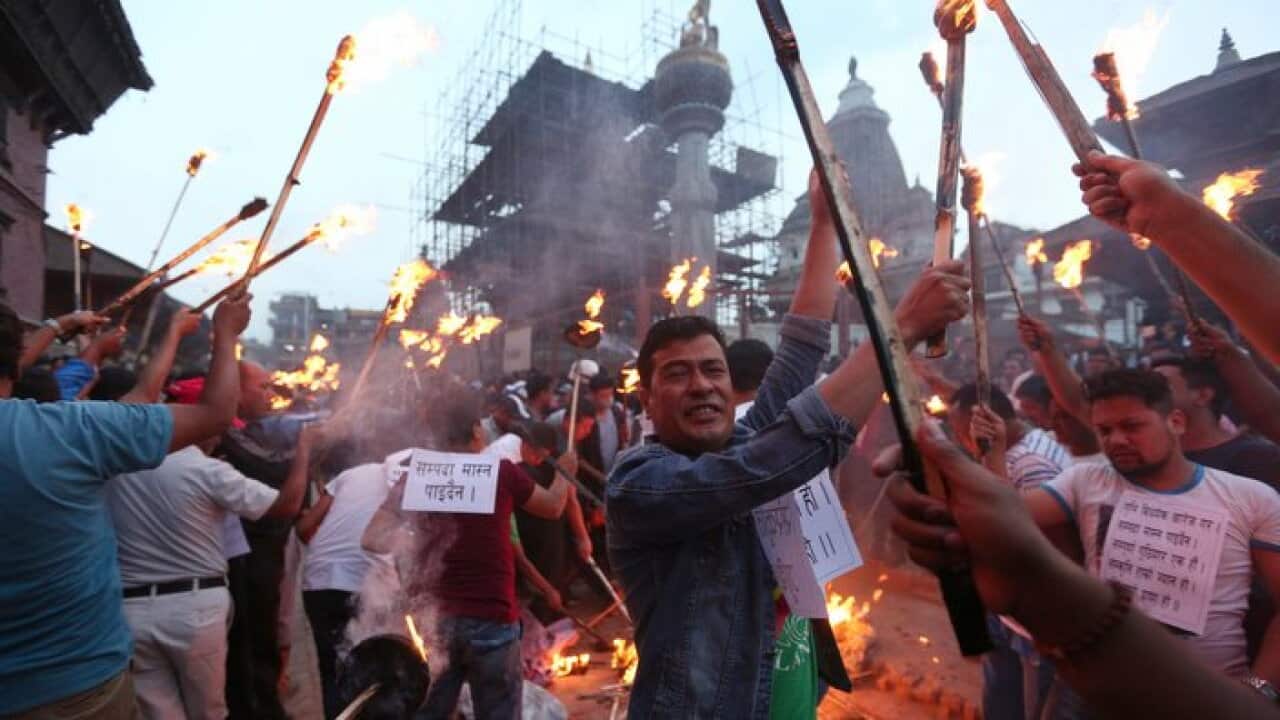 Nepali Newar community people shout slogans against government during a torch rally near Kathmandu, Nepal, Friday, June 14, 2019. (AP Photo/Niranjan Shrestha)