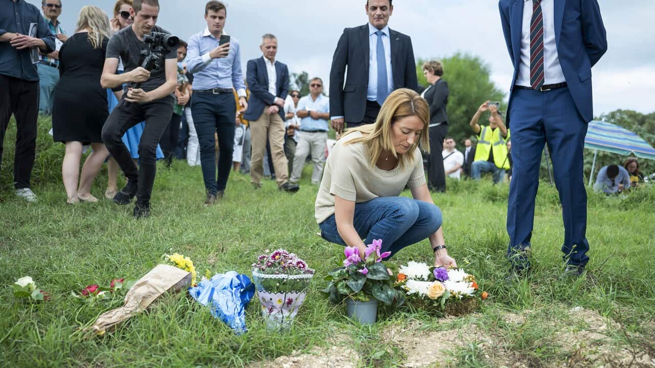 European Parliament President, Roberta Metsola, lays flowers to remember Daphne Caruana Galizia, at the place where she was killed (AAP)