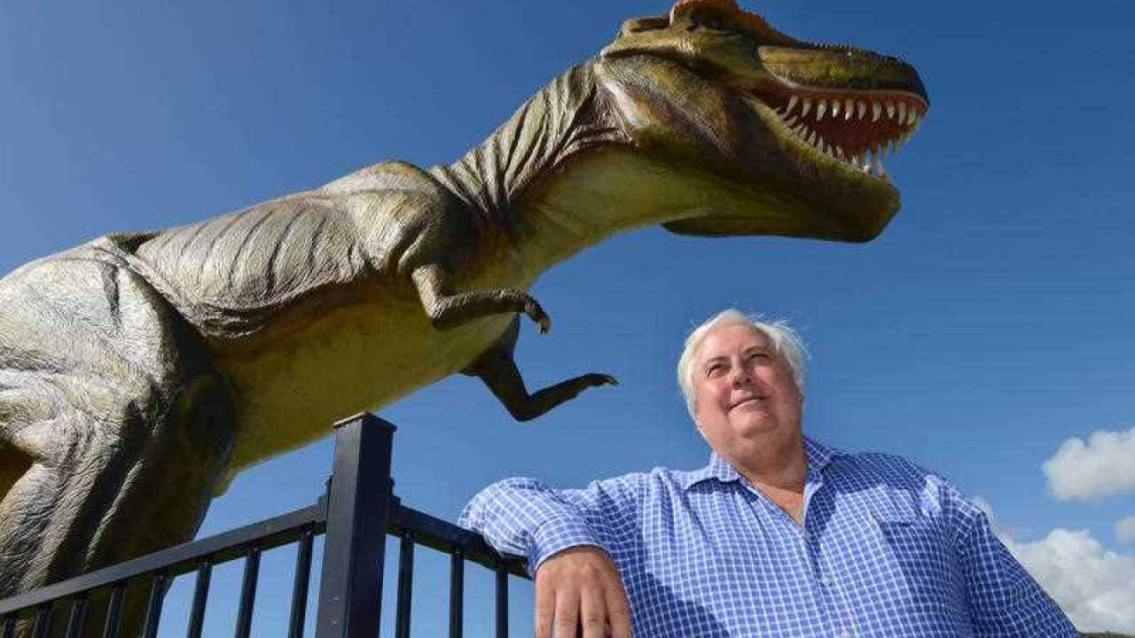 Clive Palmer poses for a photograph in front of Jeff the dinosaur at the Palmer Resort in Coolum on the Sunshine Coast, Saturday, Dec. 15, 2012. (AAP)