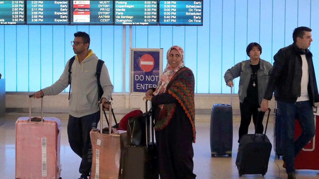Travellers from the Middle East arrives at the Los Angeles airport