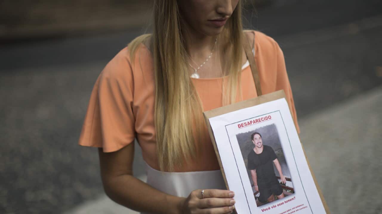 Bonnie Cuthbert shows a photo of her missing boyfriend Rye Hunt,