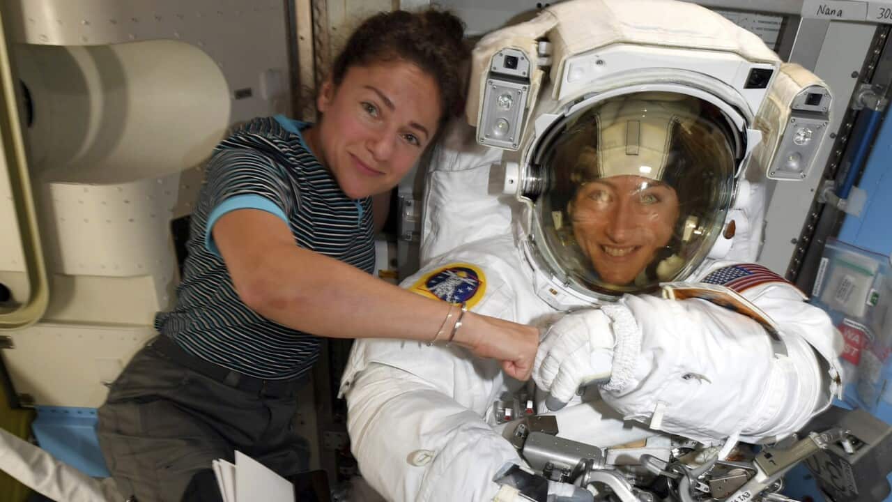 Astronauts Christina Koch and Jessica Meir pose on the International Space Station.