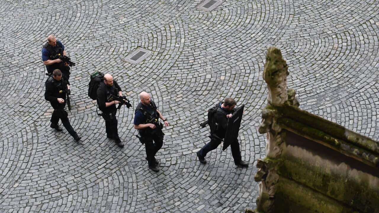 Armed police at the scene outside the Palace of Westminster, London.