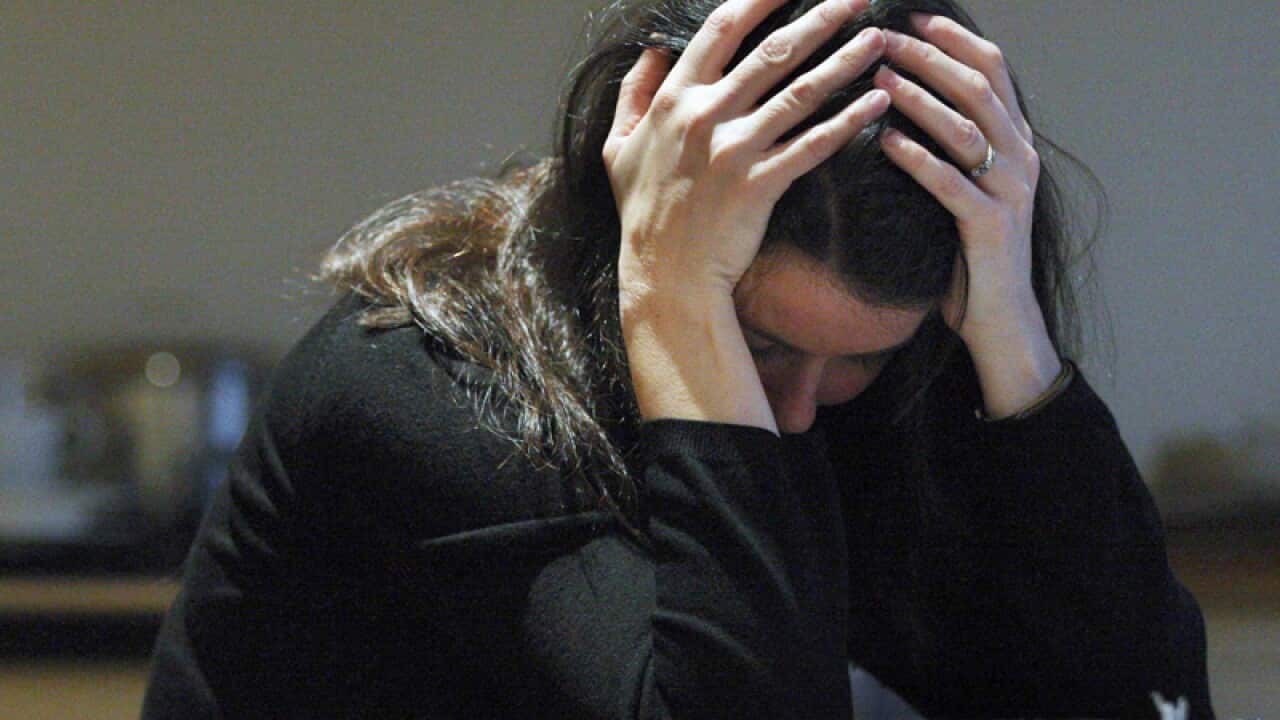 A woman with her head in her hands