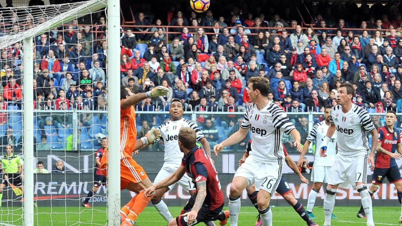 Genoa's Luca Rigoni (3L) scores the goal