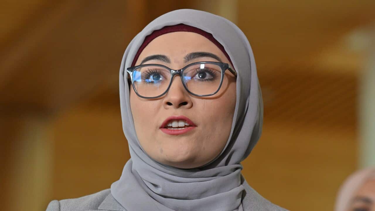 A woman in a grey hijab