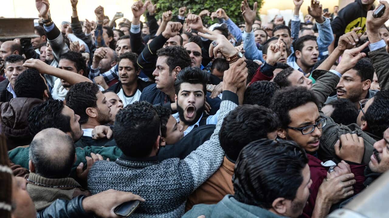 People chant slogans as they gather outside the St. Peter and St. Paul Coptic Orthodox Church following a bombing in Cairo, Egypt, 11 December 2016.