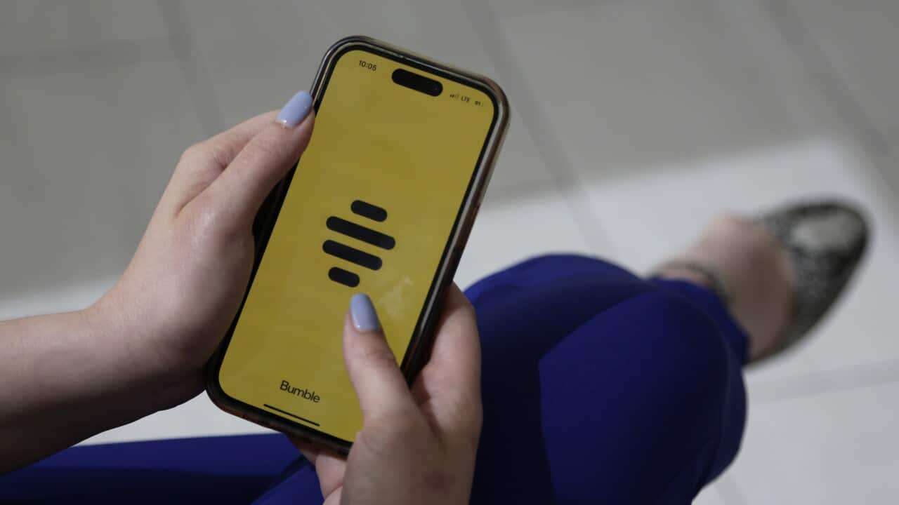 Close up of a person looking at the dating app Buble on a mobile phone.